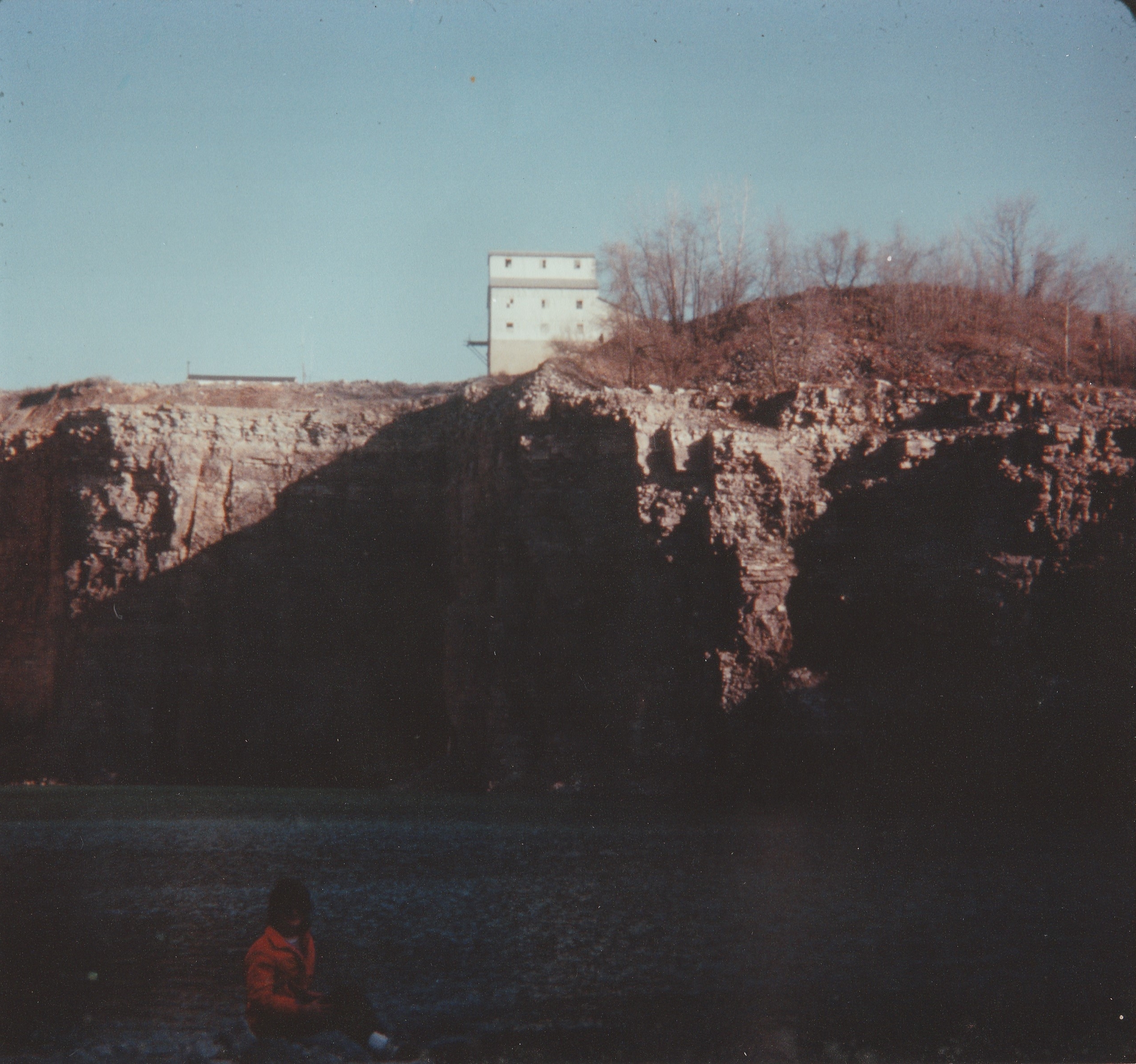 Historical photo of Gilboa Quarry as Ottawa Stone Company limestone operation showing exposed quarry walls and processing building