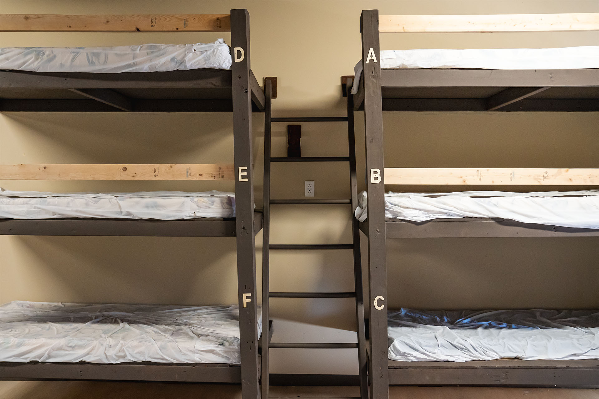 Hostel style bunkhouse lodging with triple bunk beds shared dormitory accommodations at Gilboa Quarry northwest Ohio